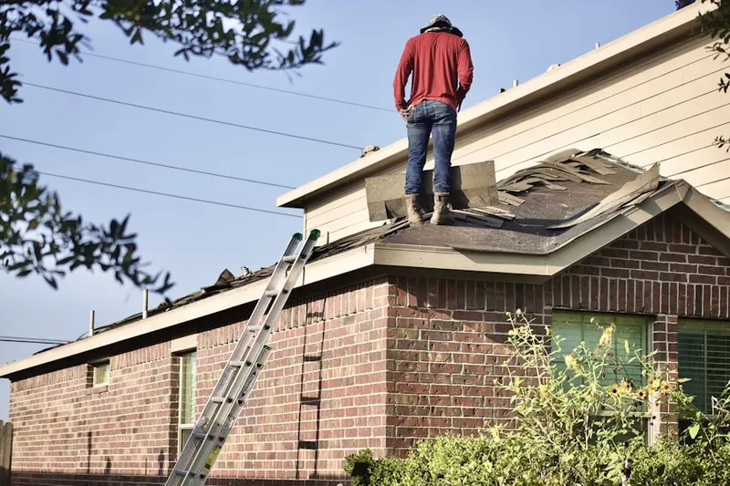 Professional roofer working on a residential roof in Castle Pines Village
